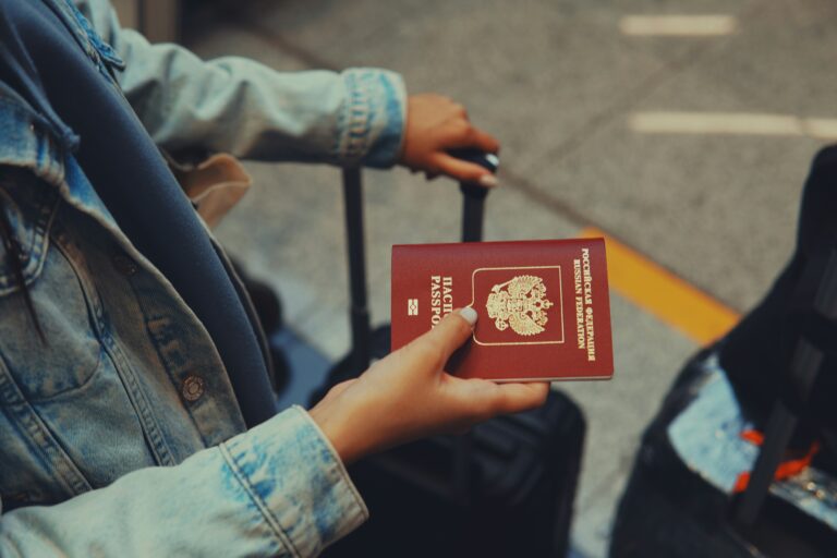 Traveler holding passport at airport for UAE visit visa application