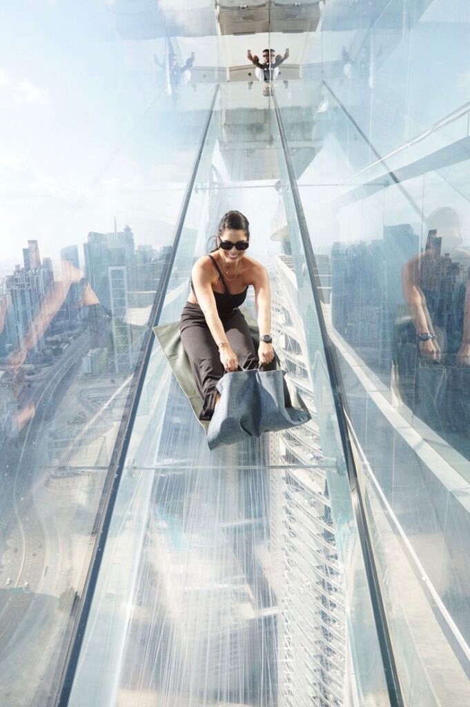 Sky Views Dubai glass slide experience with city skyline