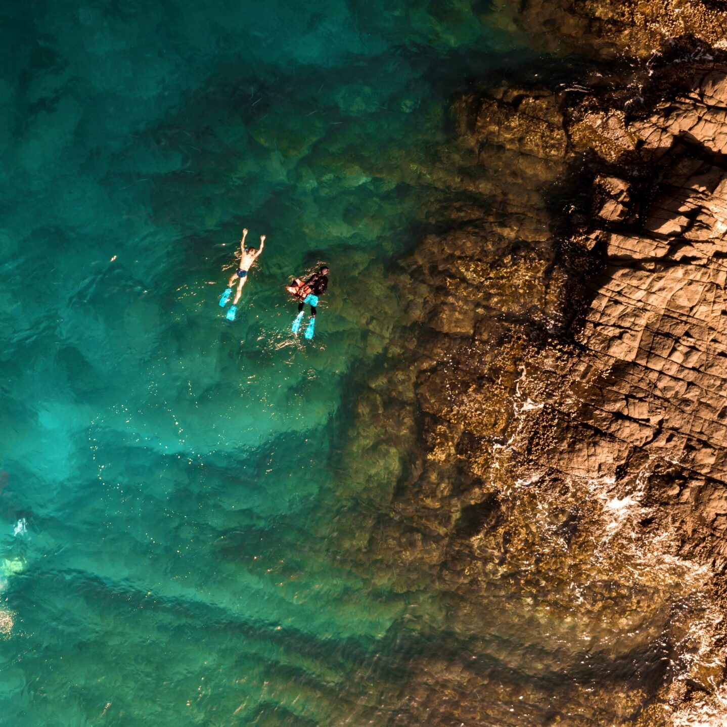Fujairah snorkeling coast Aerial view of snorkeling in clear turquoise waters along Fujairah rocky coastlin