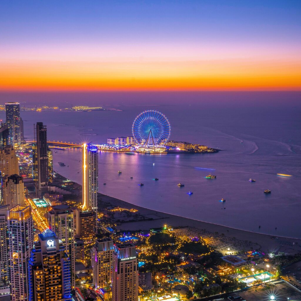Distant view of Ain Dubai from the coastline with cityscape