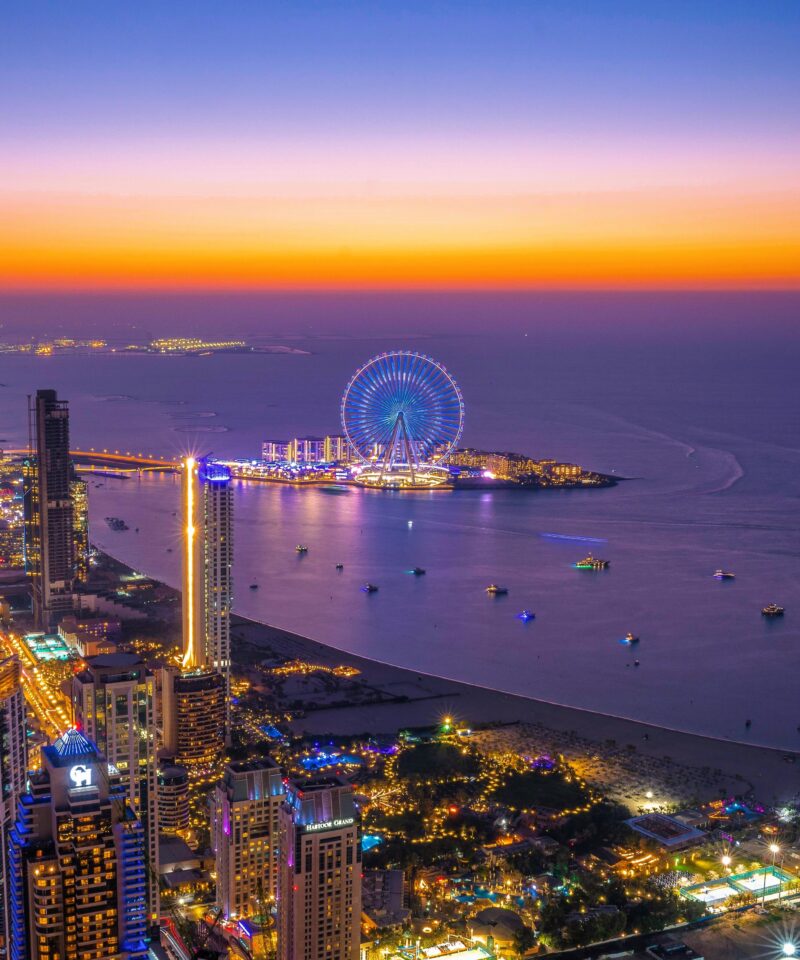 Distant view of Ain Dubai from the coastline with cityscape