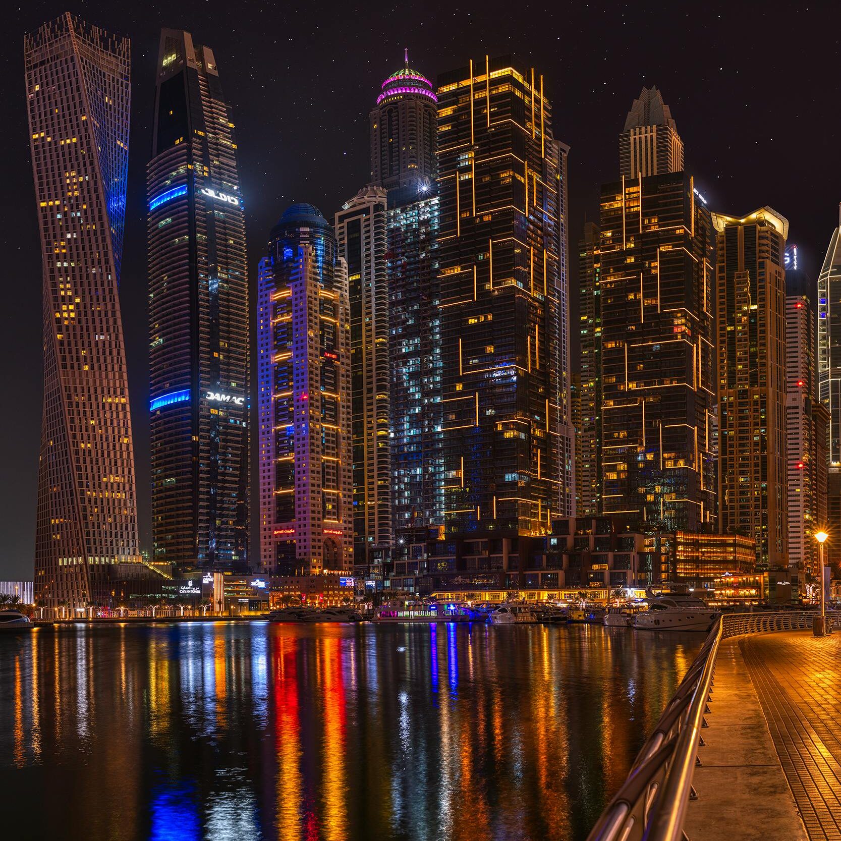 Dubai skyline at night with Marina waterfront and illuminated skyscrapers
