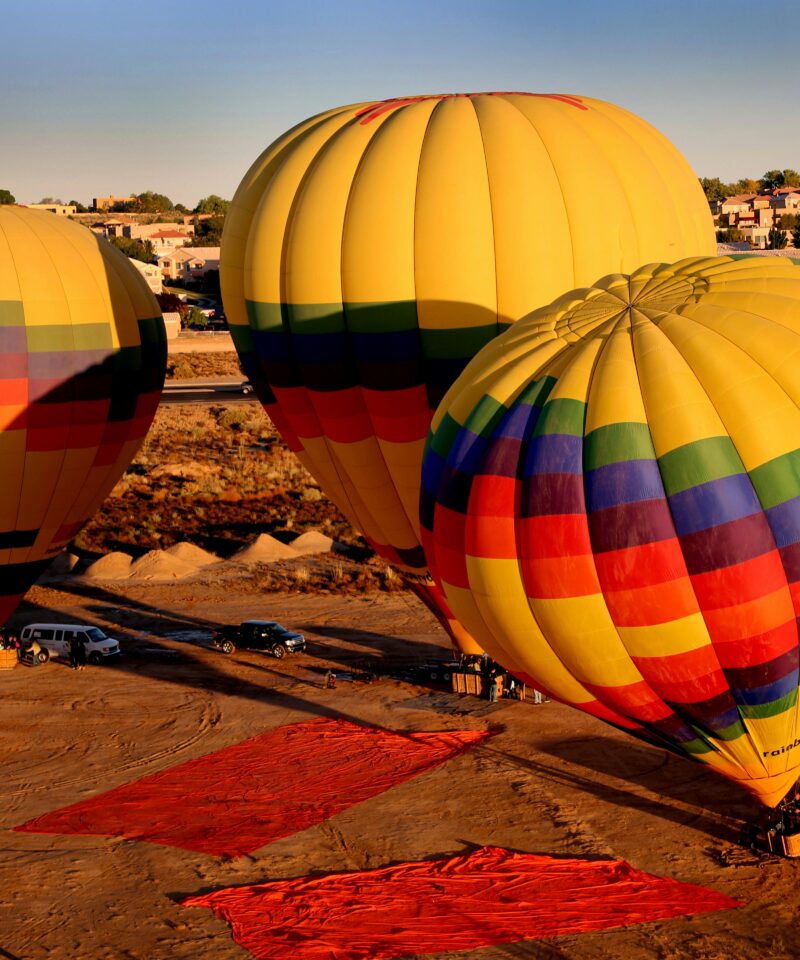 Hot air balloon flying over Dubai desert dunes at sunrise