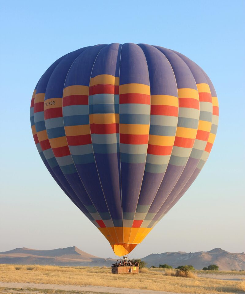 Single hot air balloon over Dubai desert landscape