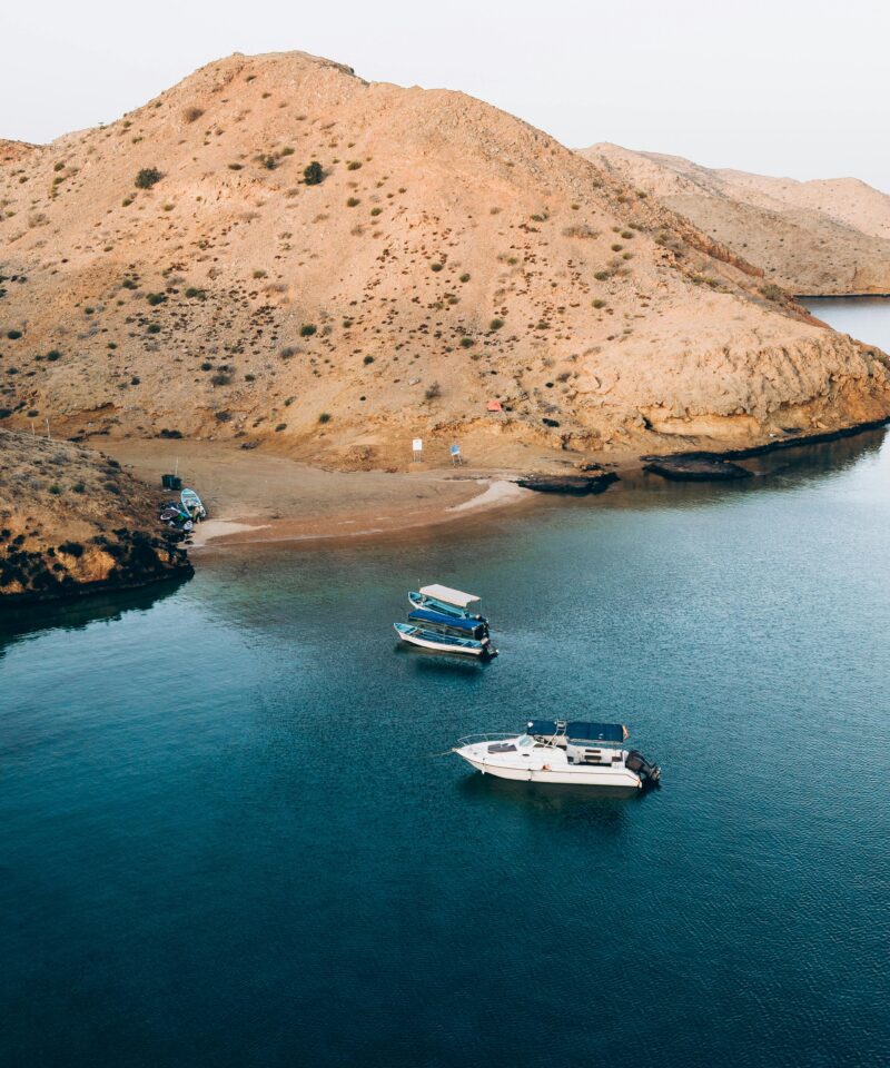 Musandam Dibba fjords with boats and mountain landscape