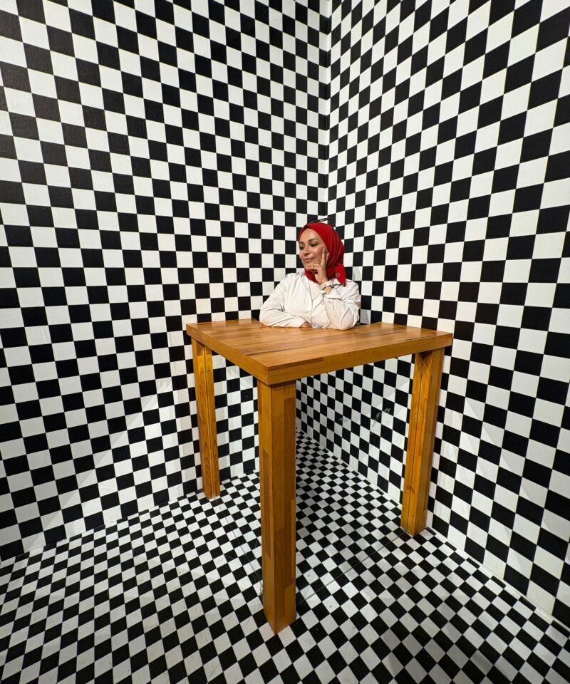 Person standing inside a glowing illusion tunnel at Museum of Illusions Dubai