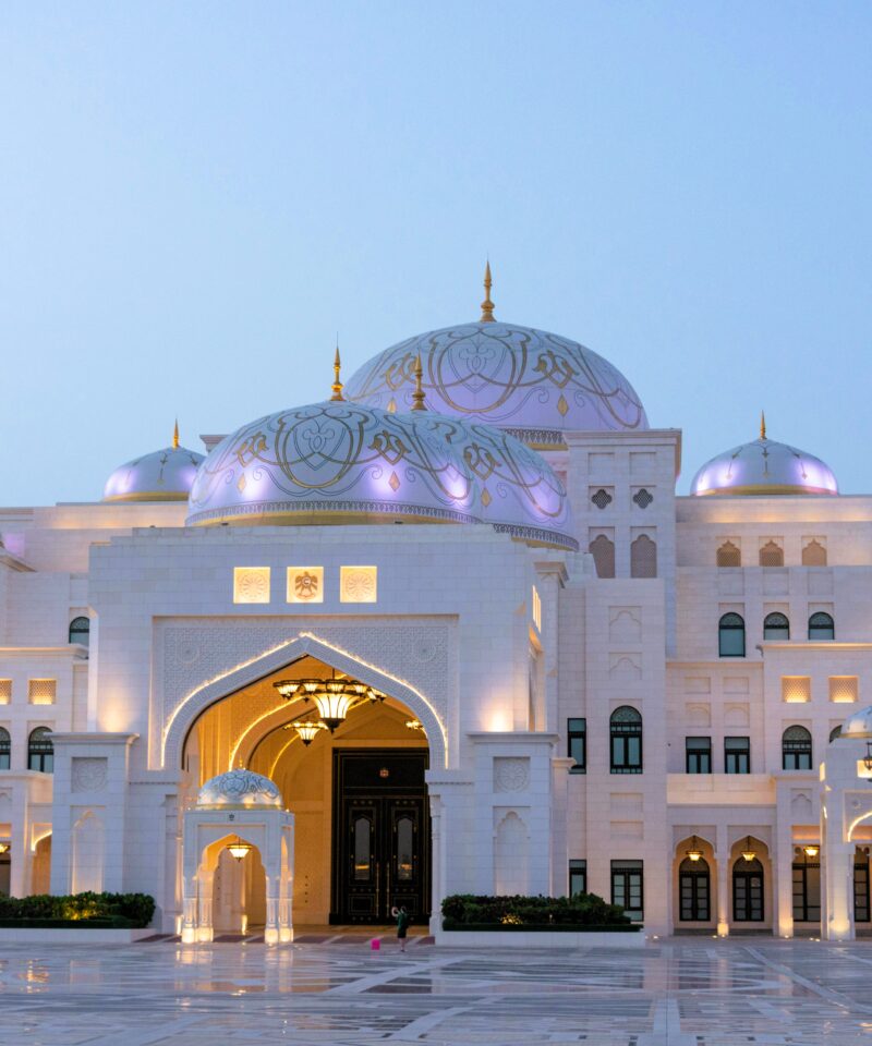 Qasr Al Watan illuminated at night with glowing lights and grand architectural details