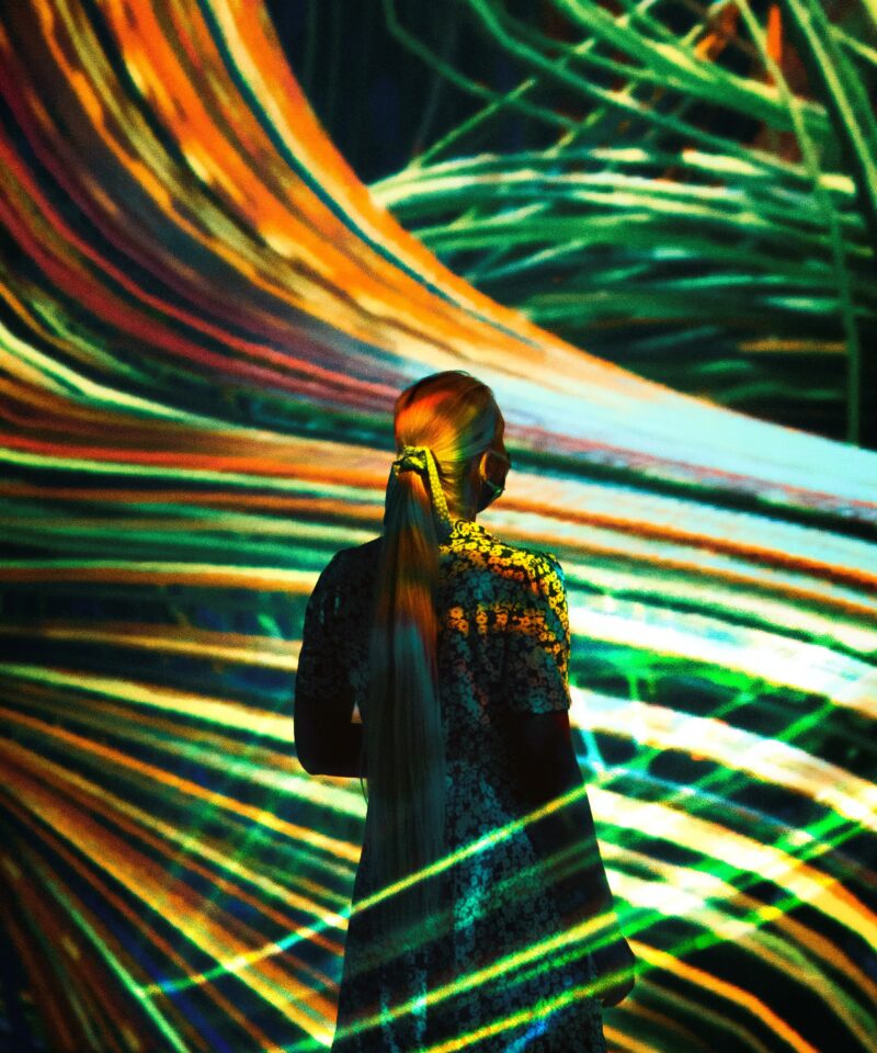 teamLab Abu Dhabi immersive digital art with flowing light trails and visitor