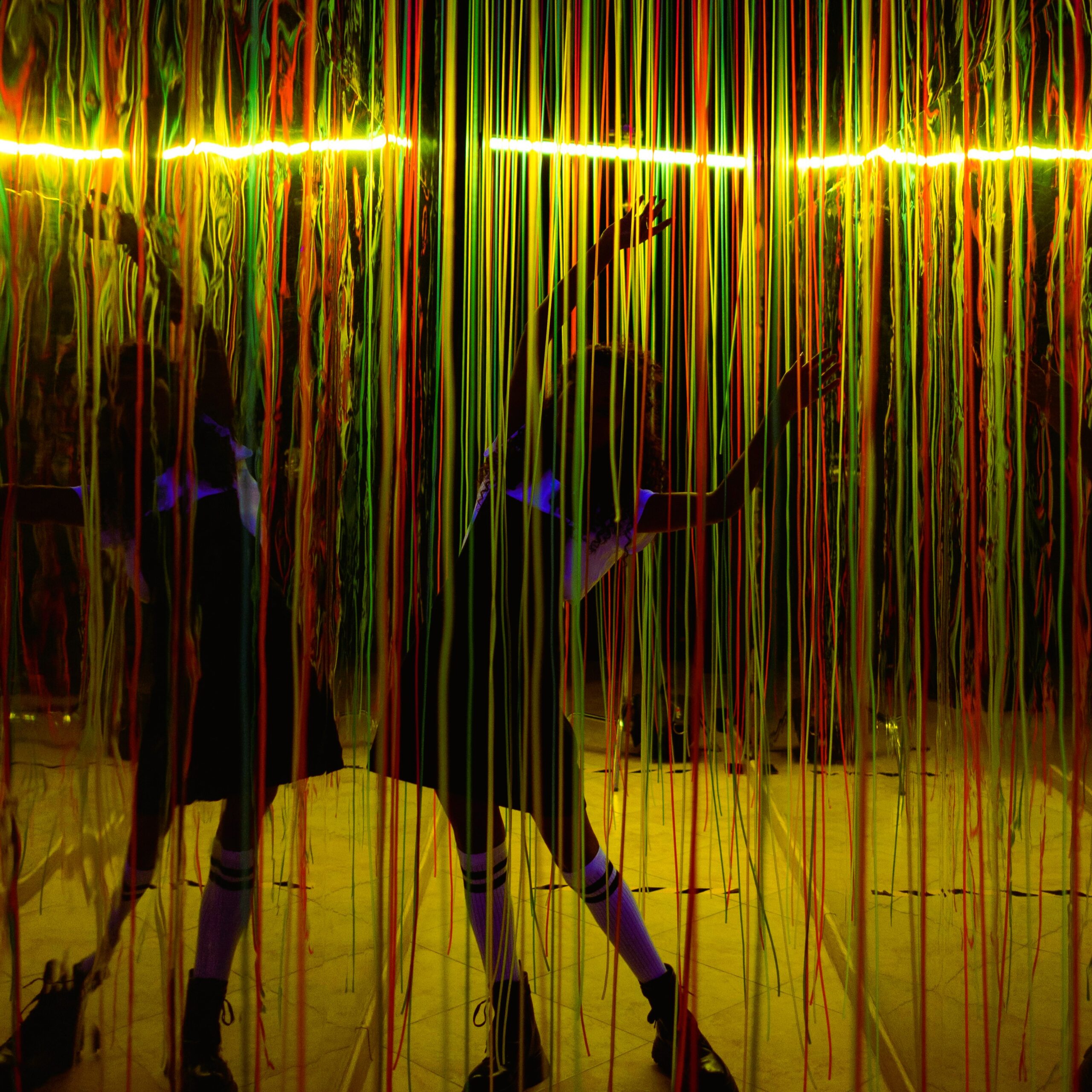 teamLab Abu Dhabi interactive light installation with hanging neon strings