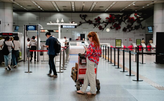 Traveler checking passport at airport after UAE visa expiry