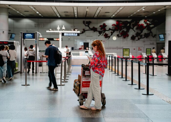 Traveler checking passport at airport after UAE visa expiry