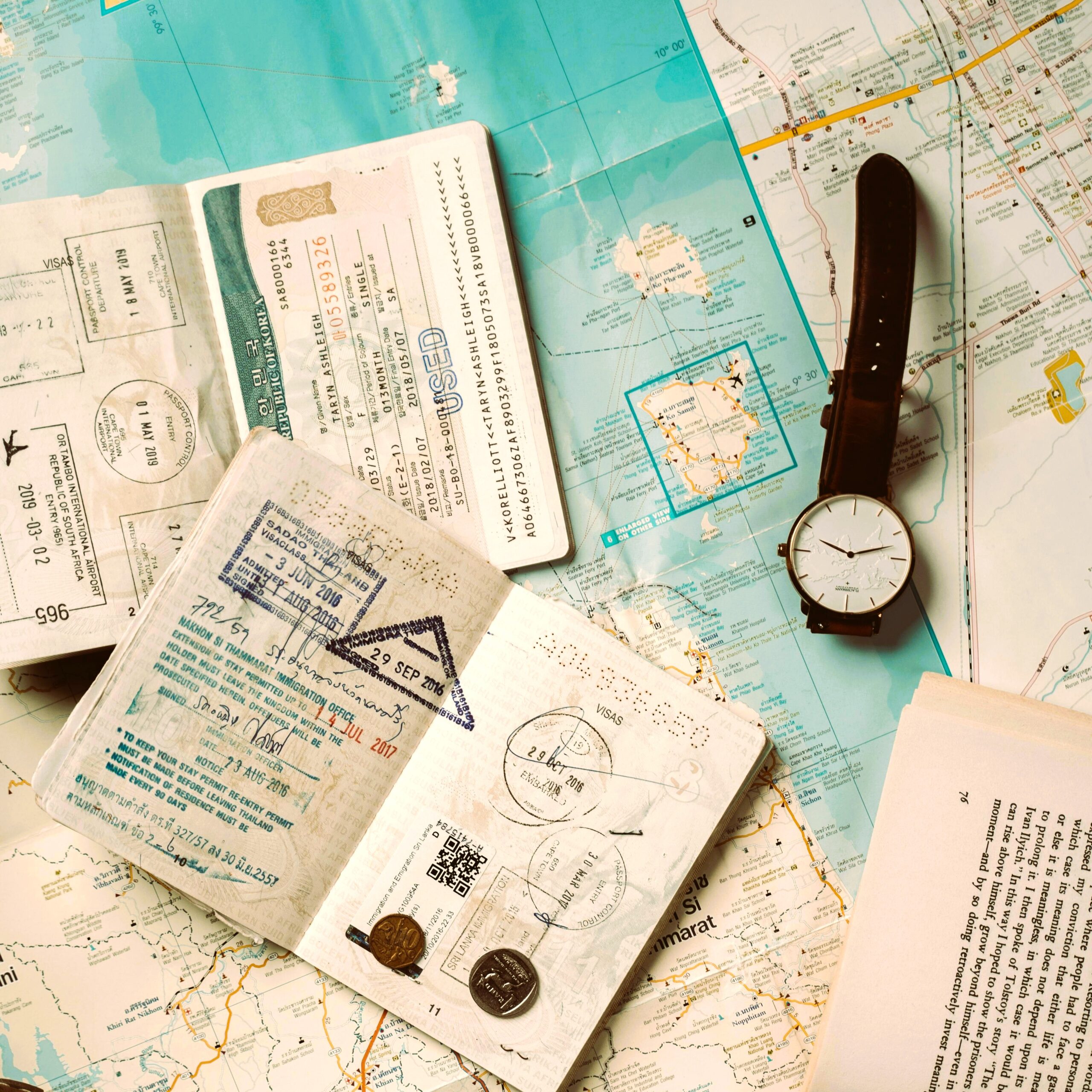 Open passport with visa stamps on map showing visa extension and overstay rules